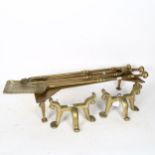 A group of brass fireside items, including tools and fire dogs