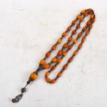 A long amber bead prayer necklace, length 61cm