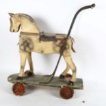 A child's Vintage painted push-along toy horse, length 60cm