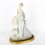A Lladro 'A Lady of Taste' porcelain figure group, model no. 1495, on display stand, height 38cm 1