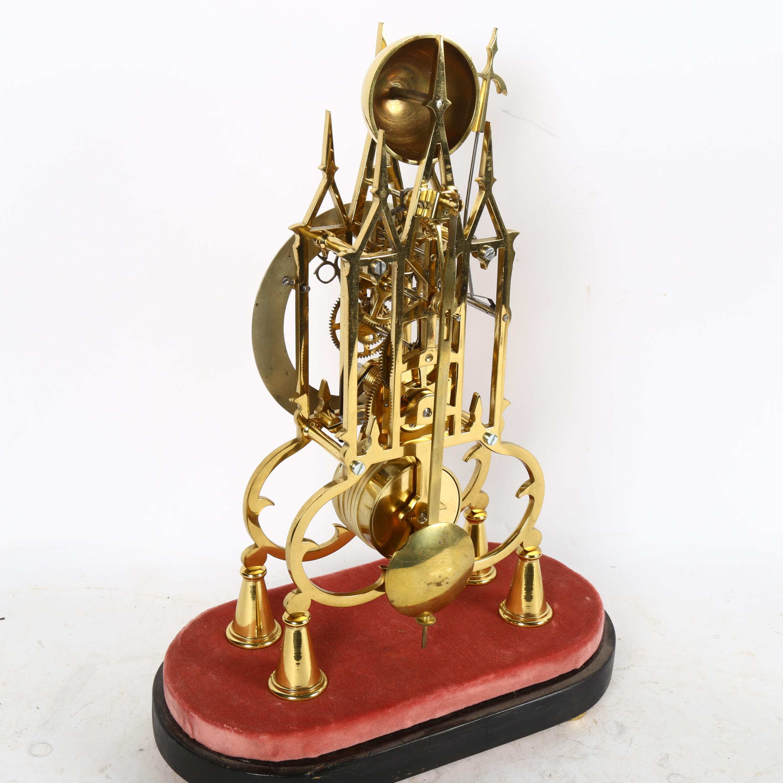 A reproduction brass skeleton clock, Gothic architectural design, with silvered chapter ring, - Image 2 of 2