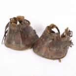A pair of leather horse shoe lawn boots, used by pony drawn early lawn mowers to protect tennis