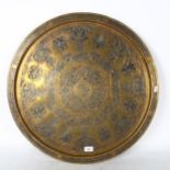 A large Turkish brass charger, with silvered and copper embossed scrolled decoration, and script