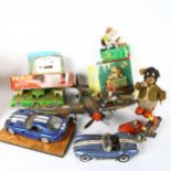 A quantity of Vintage and reproduction tin toys, including a Spitfire aeroplane