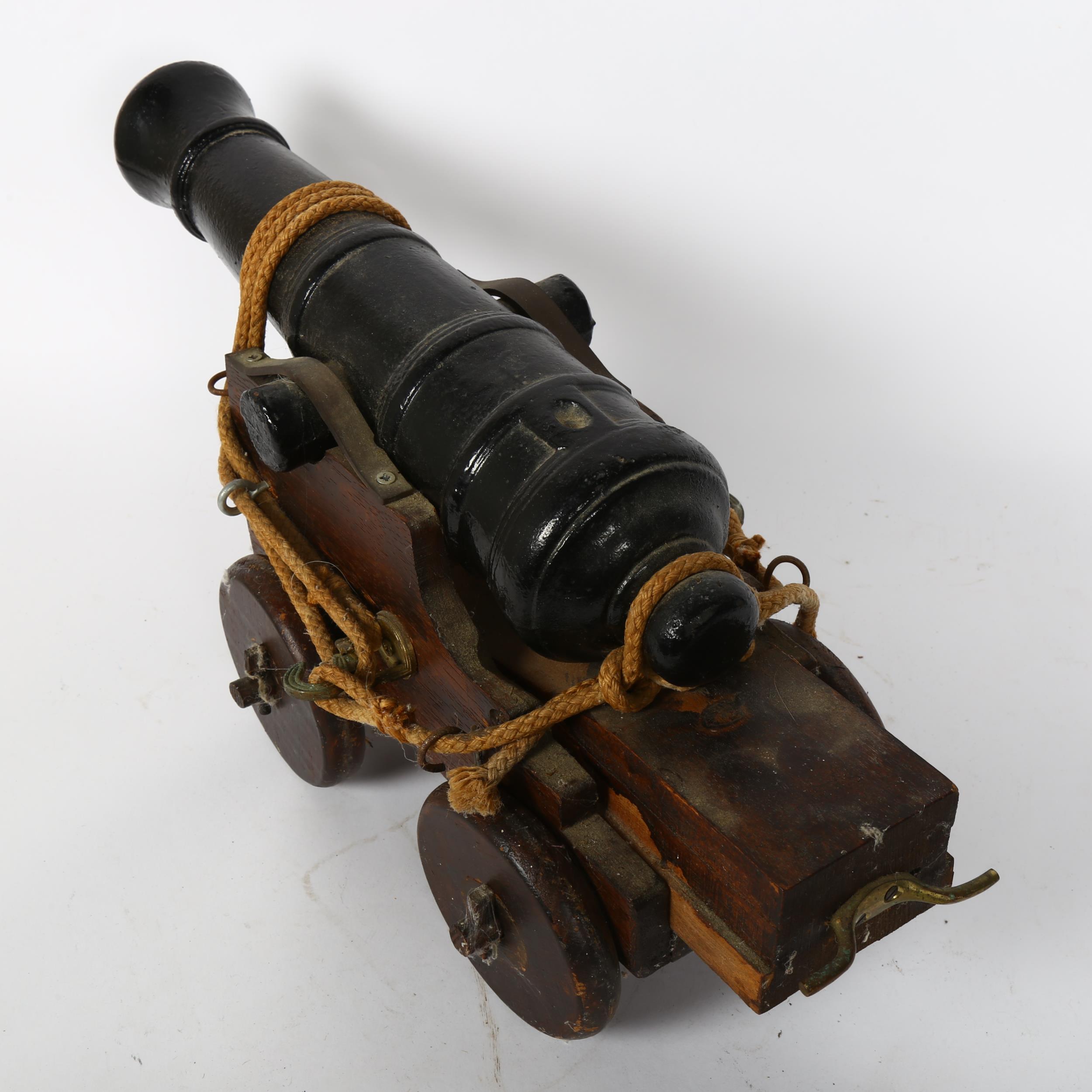 A small scale cast-iron garden cannon, on oak carriage base, barrel length 41cm - Image 2 of 2