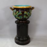 A large Sarreguemines Majolica pottery jardiniere on stand, model no. 1649, with relief applied
