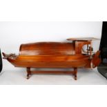 A large Oriental hardwood table-top model sampan boat on stand, length 120cm