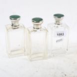 A set of George V toilet bottles, with silver and green enamel mounts, London 1931