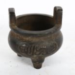 A small Chinese bronze Ding tripod incense burner, diameter 10cm