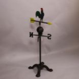 A floor standing plated cast-iron weather vane, surmounted by a cockerel, height 90cm