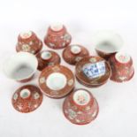 A group of Chinese red enamelled tea bowls and stands, and a blue and white tea bowl