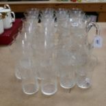 A suite of Vintage etched glassware, including 13 Champagne glasses, tumblers etc, and water jug (