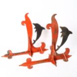 A pair of painted wrought-iron dolphin wall brackets, height 44cm, depth 34cm