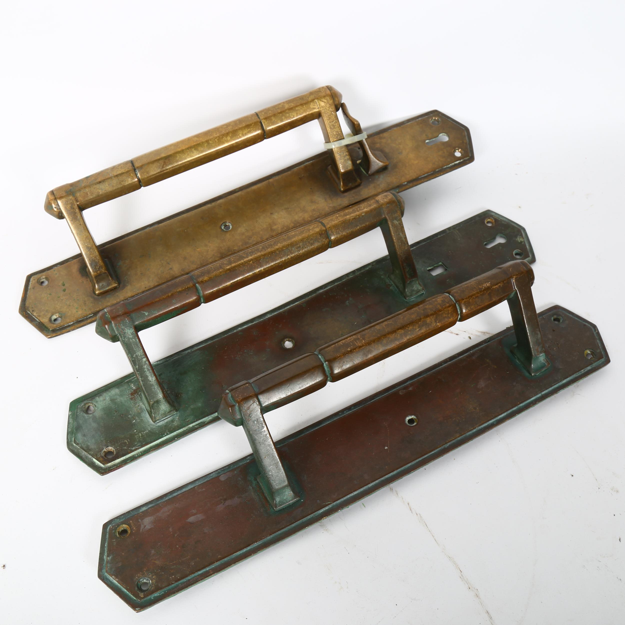 A set of 3 Antique cast-brass door handles, plate length 40cm