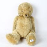 A large straw-filled teddy bear, height 65cm