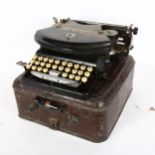 An early 20th century The Empire portable typewriter, in tin case
