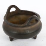 A Chinese bronze tripod incense burner, character mark on base, diameter 12cm