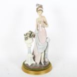 A Lladro 'A Touch Of Glass' porcelain figure group, model no. 5377, on display stand, overall height