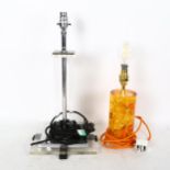 A modernist design perspex and chromed table lamp, and an amber design table lamp (2)