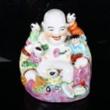 A Chinese famille rose laughing Buddha, with 5 figures of children, height 26cm