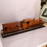 A large scratch-built wooden steam engine and carriage, and 2 sections of track, steam engine length