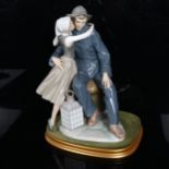 A Lladro 'The Kiss' porcelain figure group, on display stand, overall height 33cm No chips cracks or