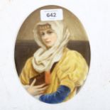 A Continental painted ceramic oval plaques, depicting a young girl holding a book, length 16.5cm