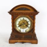 An early 20th century carved walnut-cased 8-day mantel clock with enamel dial, height 36cm