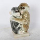 A Naples table lamp, modelled as 2 monkeys, on alabaster stand, height 26cm
