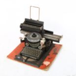 An early 20th century German tinplate toy Junior typewriter, circa 1920, by Gebruder Schmidt