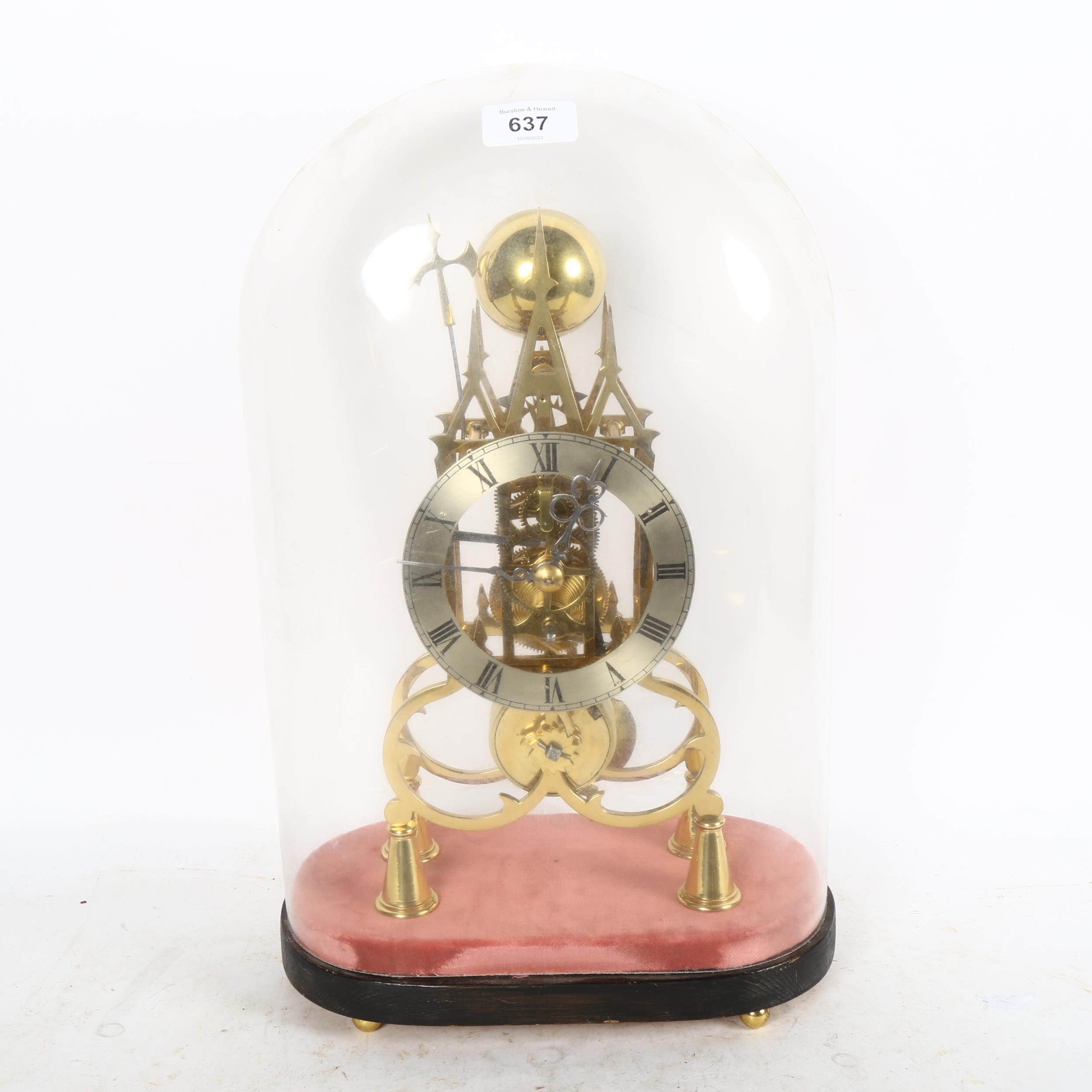 A reproduction brass skeleton clock, Gothic architectural design, with silvered chapter ring,