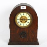 A French oak-cased dome-top mantel clock, by Japy Freres, with gilt and enamel dial, height 32cm