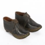 A pair of Victorian child's leather clogs, with hand-hammered steel soles, length 13cm