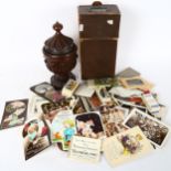 A group of Vintage postcards, and carved wood urn and cover