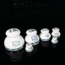 A graduated set of 6 pottery grocer's shop weights, by W & T Avery of Birmingham, comprising 2lb,