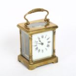 A small brass-cased carriage clock, with white enamel dial and Roman numeral hour markers, case