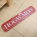 A large painted pine Harry Potter Hogwarts sign, 22cm x 105cm
