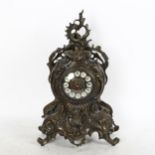 An Antique style cast-metal clock, with scrolled surround and quartz movement, height 38cm