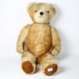 A large Vintage straw-filled teddy bear, height 80cm