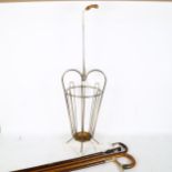 A novelty umbrella stick stand, containing various walking sticks and canes, including Duke of