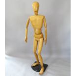 A posable wooden artist's mannequin on stand, 185cm