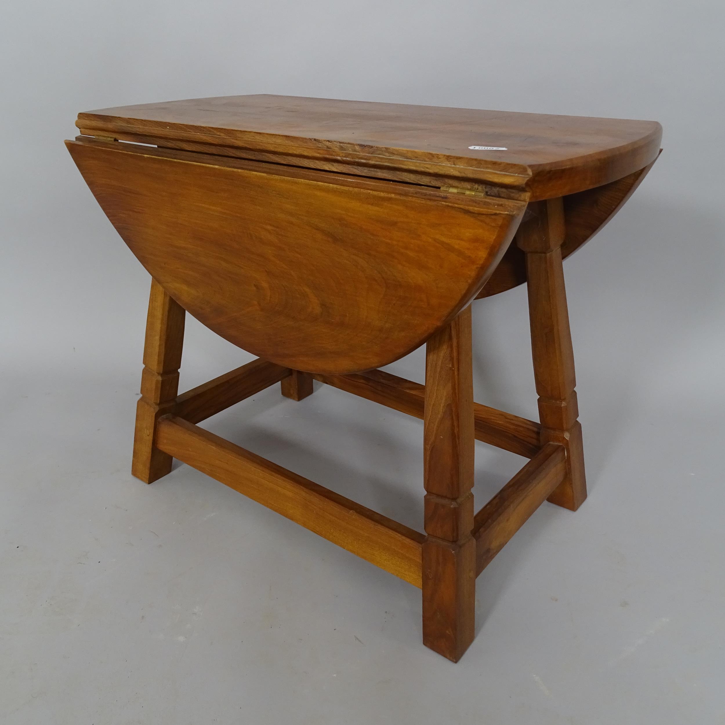 A mid-century elm oval drop leaf table, 54cm x 42cm x 30cm