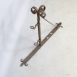 A wrought-iron wall bracket, with fitted hooks, thought to be for a pub sign 65cm x 90cm