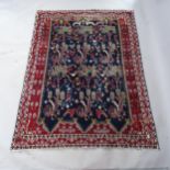 A red and blue ground Persian rug, 205cm x 148cm