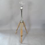 A contemporary telescopic floor lamp on tripod base