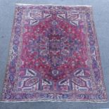 A red and blue ground Caucasian carpet, 385cm x 282cm