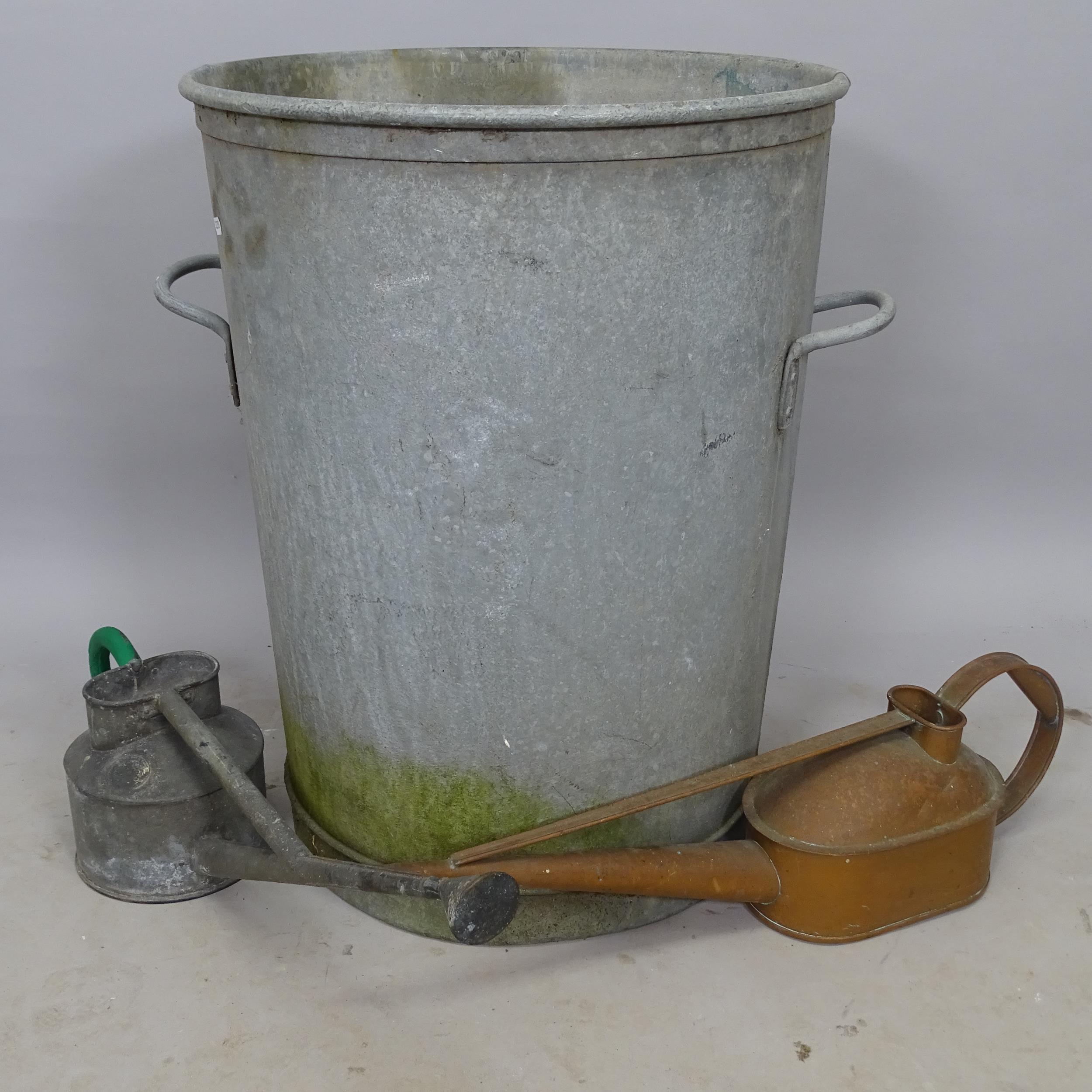 A galvanised metal waste bin, 56cm x 63cm, and a copper watering can, and a galvanised metal