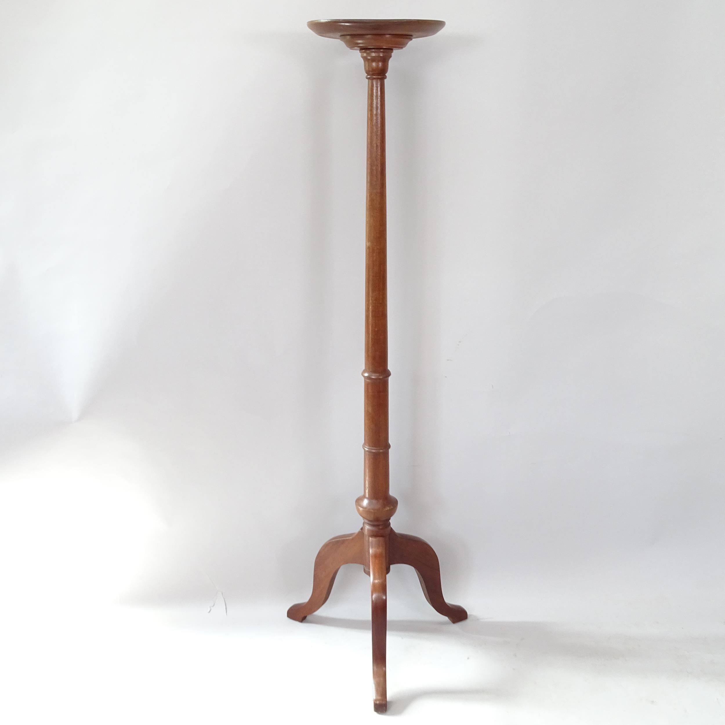 A reproduction mahogany torchere on tripod base, 143cm