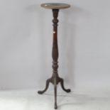 A carved oak torchere stand on tripod base, 108cm