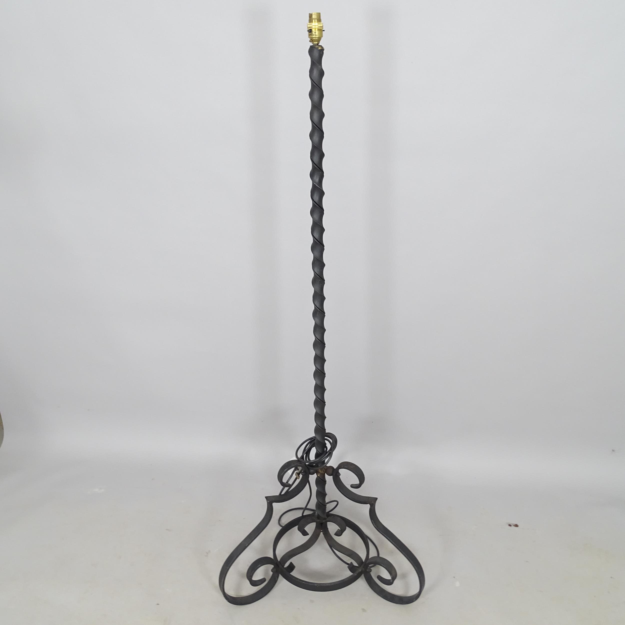 A wrought-iron standard lamp, height to bayonet 150cm